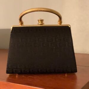 Adorable evening bag trimmed in gold.